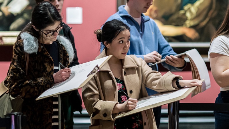 People drawing in the gallery
